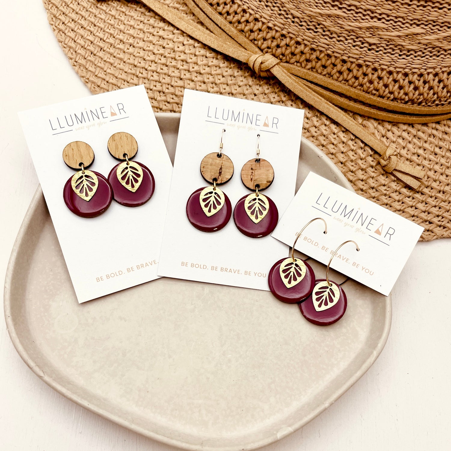 burgundy gold leaf earrings on Lluminear branded cards