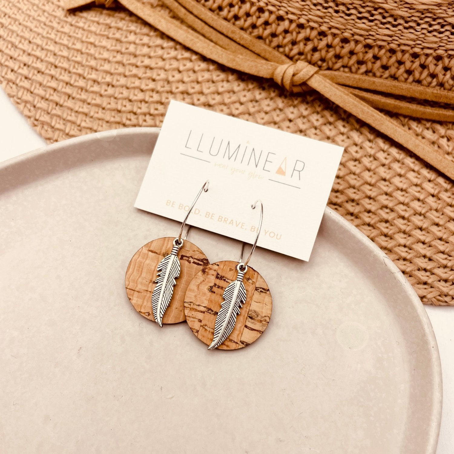 boho earrings featuring silver feather with natural cork on hypoallergenic sterling silver hoops for sensitive ears