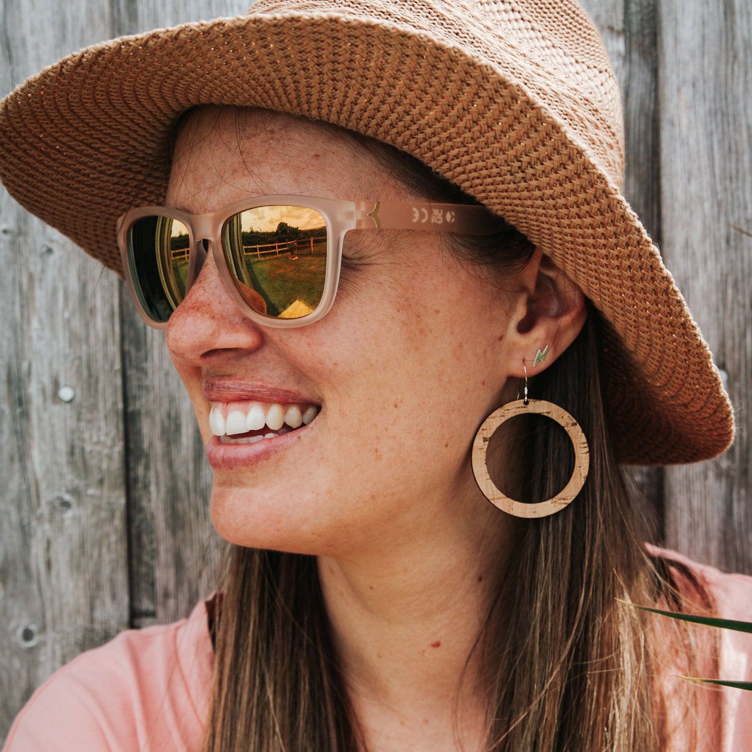 natural cork wooden circle earrings on woman with sunny boho tropical vibe